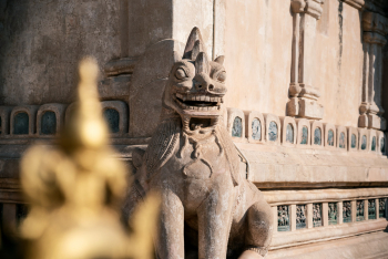 A Statue Of A Lion At A Temple In Bagan, Myanmar