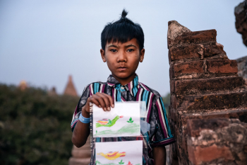 Young Boy Is Selling Postcards At A Temple In Bagan, Myanmar