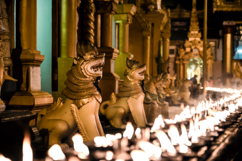 Candles And Statues At Shwedagon In Yangon, Myanmar